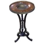 AN EBONISED OCCASIONAL TABLE Having a marquetry inlaid top set with a brass dish and gallery, raised