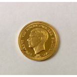 A 24CT GOLD MILESTONE OF THE MILLENNIUM COIN Featuring a portrait of King Edward VIII.