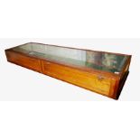 A VICTORIAN OAK GLAZED COUNTER TOP JEWELLERY DISPLAY CABINET. (178cm x 56cm x 22cm)