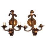 WITHDRAWN A PAIR OF GILT METAL WALL SCONCES Having scrolled and textured patterned three branch arm