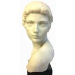 A WHITE MARBLE BUST OF A ROMAN BOY Wearing a headband and raised on a square black slate base. (