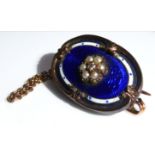 A 19TH CENTURY YELLOW METAL, DIAMOND, SEED PEARL AND ENAMEL BROOCH The oval with scrolled edge,