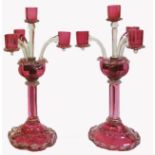 A RARE PAIR OF VICTORIAN CRANBERRY GLASS CANDELABRA The four branch with clear glass scrolled edge