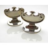 A PAIR OF EDWARDIAN SILVER MENU HOLDERS Having a scrolled pierced mount and raised on a circular