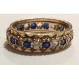 A VINTAGE 9CT GOLD SAPPHIRE AND PASTE SET ETERNITY RING Having a row of sapphires interspersed