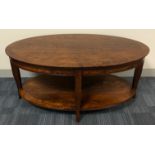 A PAIR OF REGENCY DESIGN SATIN OVAL TWO TIER OCCASIONAL TABLES. (w 110cm x d 61cm x h 51cm)