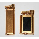 DUNHILL, TWO 20TH CENTURY GOLD PLATED RECTANGULAR LIGHTERS With reeded sides and red enamel