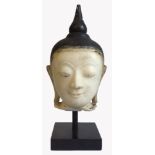 AN ORIENTAL SHAN CULTURE ALABASTER BUDDHA HEAD Having a conical finial and elongated earrings,