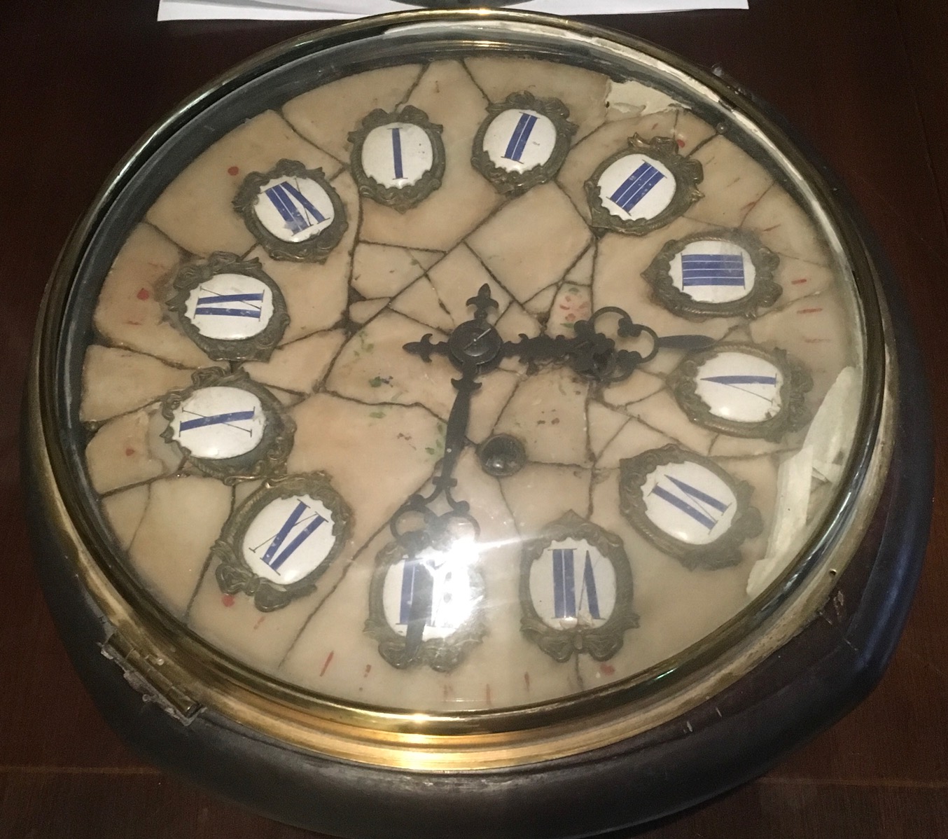 A 19TH CENTURY WALL CLOCK The circular dial with enamelled Roman numerals. (diameter 30cm)