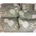A SET OF SIX SILK CUSHIONS Gilt ground with white flowers and green leaves. Each curtain measuring