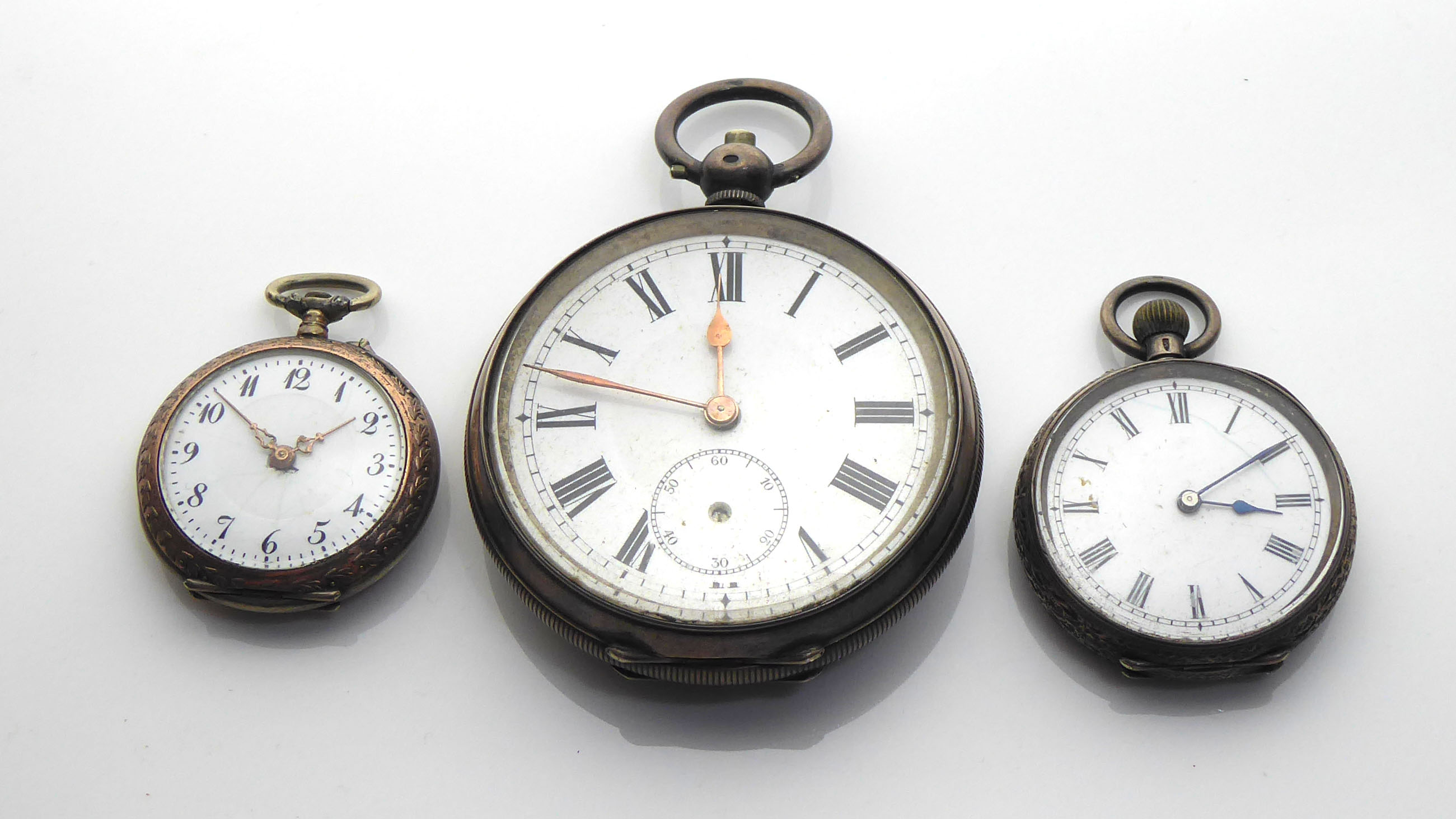 A VICTORIAN SILVER POCKET WATCH Along with two silver fob watches.