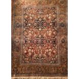 AN ANTIQUE PERSIAN RUG The central madder field enclosed by running borders, along with another. (