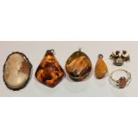 A COLLECTION OF THREE VINTAGE AMBER PENDANTS Pear shape with wire attachments, together with a 9ct