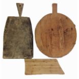 A COLLECTION OF THREE VINTAGE OAK AND PINE CHOPPING BOARDS One wedge shape, applied with a