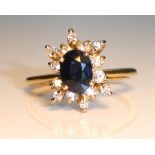 AN 18CT GOLD, PLATINUM, DIAMOND AND BLUE TOPAZ RING Having an oval cut blue topaz flanked by