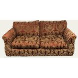 A GOOD LARGE TWO SEATER SOFA BED In floral fabric upholstery on a burgundy ground. (w 197cm x d