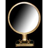 AN ART DECO BRASS DRESSING TABLE MIRROR Raised on shaped support over a platform base. (h 54cm x w