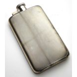 A LARGE EARLY 20TH CENTURY SILVER HIP FLASK Having a screw cap with gilt interior and textured