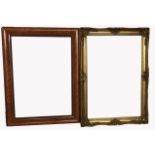 A DEEP CUSHION FAUX WALNUT PICTURE/MIRROR FRAME Along with gilt frame. (75cm x 104cm) (74cm x
