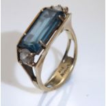 A VINTAGE 9CT GOLD, AQUAMARINE AND PASTE SET DRESS RING Having a single baguette cut aquamarine