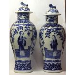 A NEAR PAIR OF 19TH CENTURY CHINESE BLUE AND WHITE PORCELAIN VASES AND COVERS Having dogs of fo
