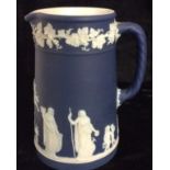 A VICTORIAN WEDGWOOD JASPERWARE JUG Having applied classical figures on a dark blue ground. (