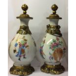 A PAIR OF 19TH CENTURY CHINESE FAMILLE ROSE PORCELAIN AND ORMOLU BALUSTER VASES Hand painted with