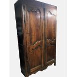 A LARGE IMPRESSIVE 18TH CENTURY ARMOIRE The carved panel doors with steel hinges on cabriole