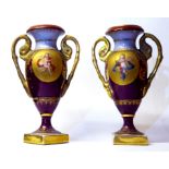A PAIR OF 19TH CENTURY VIENNA PORCELAIN MINIATURE CAMPAIGN VASES Hand painted with winged cherubs