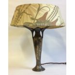 AN ART NOUVEAU STYLE WHITE METAL BALUSTER LAMP With embossed floral decoration and stylized