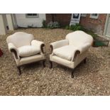 A PAIR OF EARLY 20TH CENTURY EASY ARMCHAIRS In calico upholstery, raised on cabriole legs.