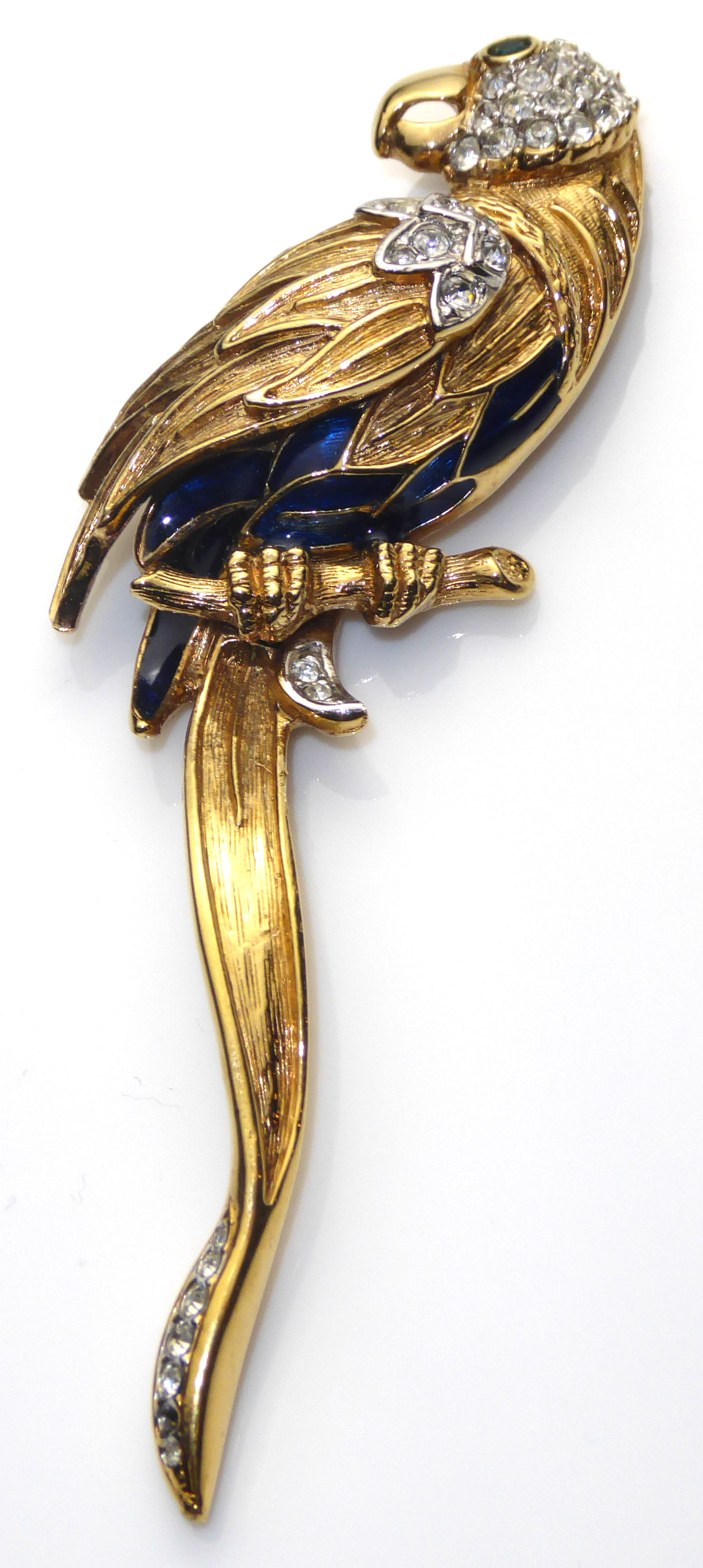 A 20TH CENTURY GOLD PLATED, ENAMEL AND PASTE SET PARROT BROOCH Perched on a branch with blue