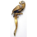 A 20TH CENTURY GOLD PLATED, ENAMEL AND PASTE SET PARROT BROOCH Perched on a branch with blue