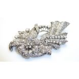 A WHITE METAL AND DIAMOND SORAY BROOCH The arrangement of multi round and baguette cut diamonds
