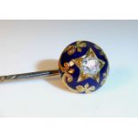 A 19TH CENTURY DIAMOND AND ENAMEL TIEPIN Having a single diamond held in a circular blue enamel