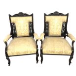 A PAIR OF EDWARDIAN OPEN ARMCHAIRS With show wood frames, upholstered seats and backs.