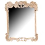 A DECORATIVE LIMED WOOD FRAMED MIRROR The pierced frame carved with foliage. (99cm x 120cm)