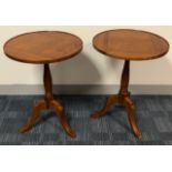 A PAIR OF GEORGIAN STYLE OAK SIDE TABLES The circular tops, raised on turn columns with splayed