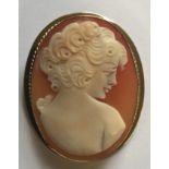 A HALLMARKED 9CT GOLD MOUNTED SHELL CAMEO BROOCH With pendant loop fitting, the female portrait in
