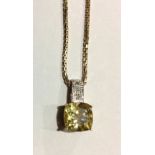 A VINTAGE YELLOW METAL, CITRINE AND DIAMOND PENDANT The square cut stone held in an engraved pierced