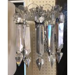 A PAIR OF VICTORIAN CUT CRYSTAL GAS WALL LIGHTS Having floral cast metal mounts, cut glass arms