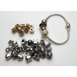 PANDORA, A COLLECTION OF NINE 14CT GOLD BEADS Having various embossed designs and three set with