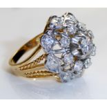 A VINTAGE 18CT GOLD AND DIAMOND CLUSTER RING Having a central round cut diamond surrounded with