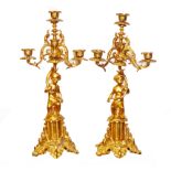 A PAIR OF 19TH CENTURY GILT BRONZE FOUR BRANCH CANDELABRA Figured with putti seated on plinths. (