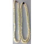 TWO VINTAGE MOONSTONE NECKLACES The double strand of graduating spherical moonstones leading to a