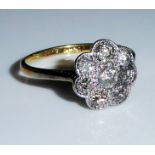 AN ANTIQUE 18CT GOLD AND PLATINUM SET DAISY CLUSTER RING