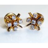 A PAIR OF YELLOW METAL AND DIAMOND EARRINGS Each set with six round cut diamonds and held in a