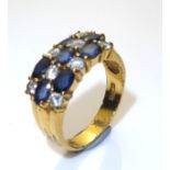 AN 18CT GOLD PLATE, TOPAZ AND PASTE SET DRESS RING Having an arrangement of oval cut blue topaz