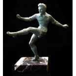 A 20TH CENTURY COLD PAINTED STATUE OF A FOOTBALLER Having a verdigris finish and raised on a black
