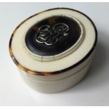 AN EARLY 20TH CENTURY IVORY OVAL TRINKET BOX With white metal monogram to lid and tortoiseshell
